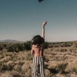 topless person throwing black hat
